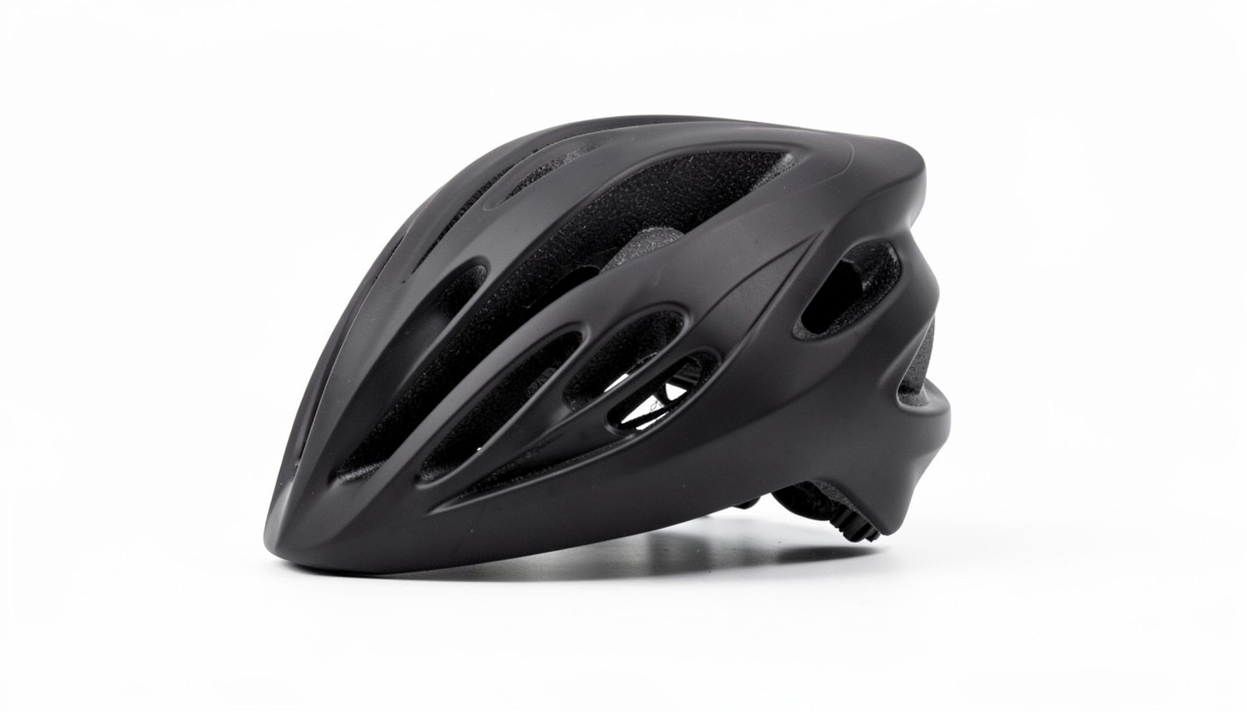 A black bicycle helmet with multiple ventilation slots photographed against a plain white background