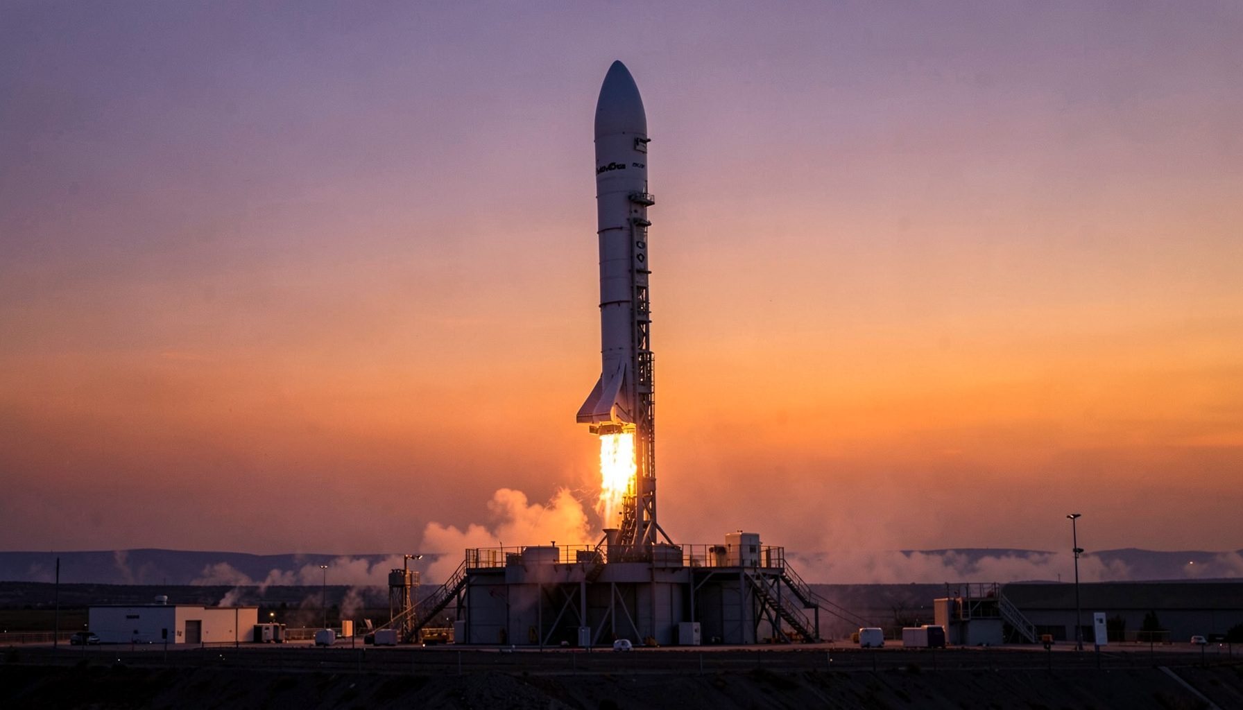 A rocket on its launch pad at twilight with a purple-to-orange gradient sky and bright engine flame